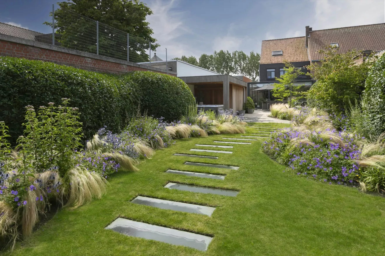Speelse kusttuin met Dutchborder vol bloemenpracht en tuinberegening te Oostduinkerke (15) -  - Tuinaanleg